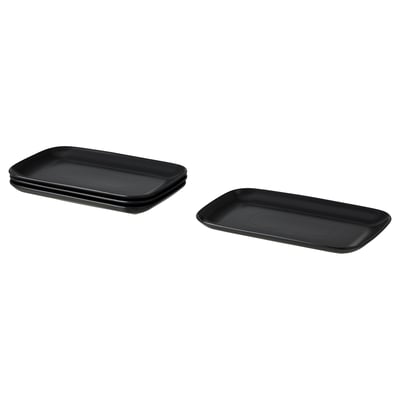 Image four black rectangular FÄRGKLAR plates with smooth edges. Simple, modern design in stoneware. Stacked in pairs.