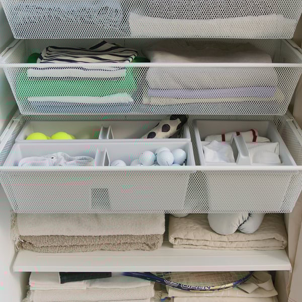 Organised drawer inserts holding sports equipment and accessories.