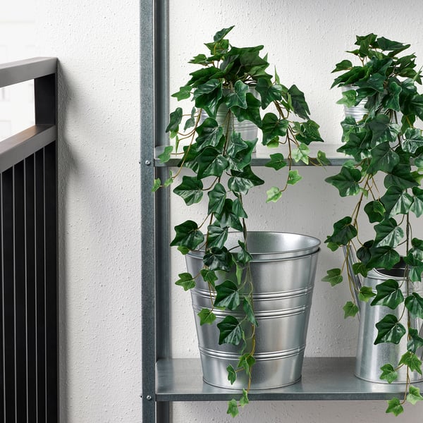 Potted artificial plants on metal shelf, suitable for indoor or outdoor use.