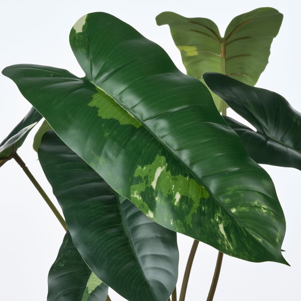Vibrant, realistic artificial plant leaves with lifelike texture and green hues, designed with recycled materials for eco-friendly decoration.