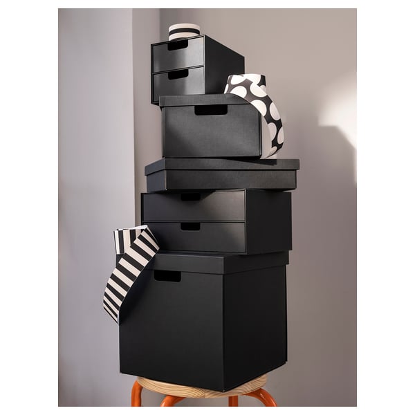 Stack of black FJÄDERHARV boxes. Top box has a patterned design.