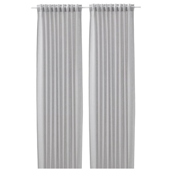 Two light-colored curtains hang side by side, featuring simple, pleated designs for privacy and light control.