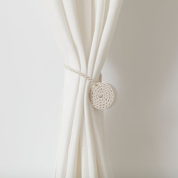 White rope-like curtain tie-back with magnetic ends. Easily keeps curtains open without damaging walls.