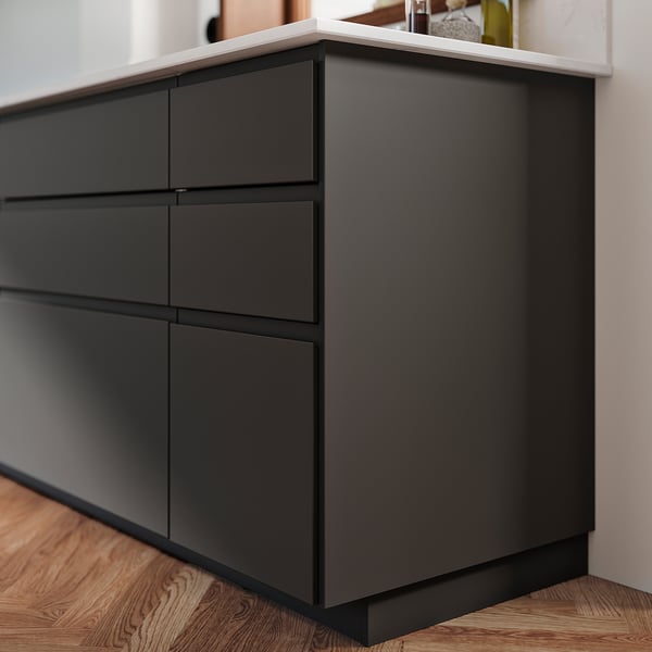 Black FÖRBÄTTRA dresser, made of particleboard with plastic edging, four drawers, sleek modern design.