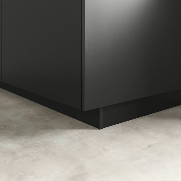 Black kitchen cabinet plinth, neatly covering floor gap, providing a clean finish.