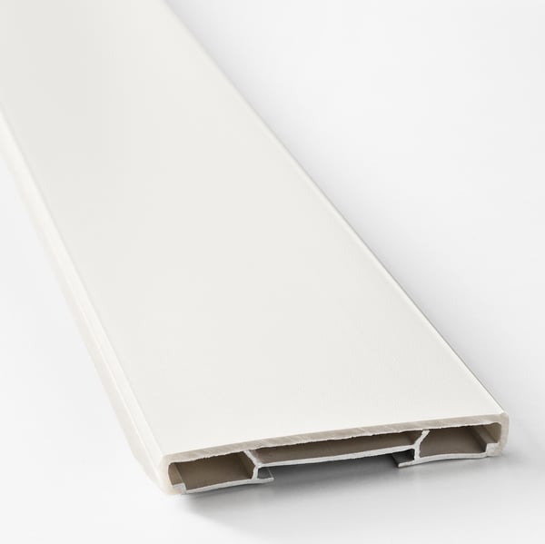 Close-up of a smooth, white plastic kitchen plinth. Shows clean edges and sturdy construction.