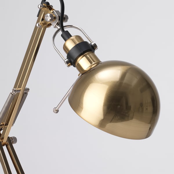 Gold adjustable desk lamp with shiny metallic finish, flexible arm, and reflective spherical shade.
