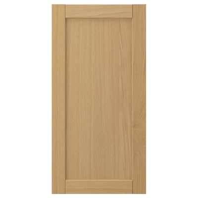 A FORSBACKA cabinet door in warm oak veneer featuring a classic, framed design with bevelled edges.
