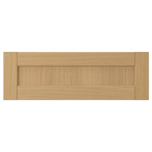 A FORSBACKA drawer front in warm oak wood. Its classic frame design bevelled edges.