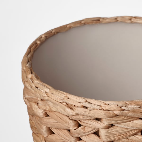 Handwoven basket, close-up. Crafted from natural water hyacinth, showcasing intricate weave and rustic texture.