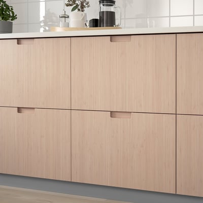Modern kitchen cabinets with integrated bamboo handles, offering a clean, natural aesthetic and durable storage.