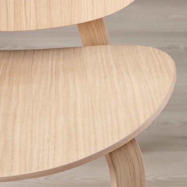 Smooth, light wooden chair showcasing durable, layered design; ensures comfort and style.
