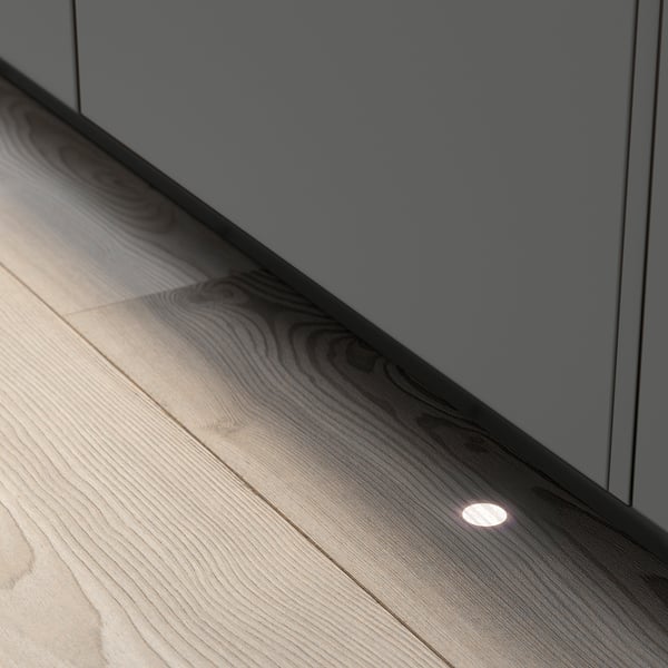 Modern kitchen scene with built-in dishwasher, lit floor beam.