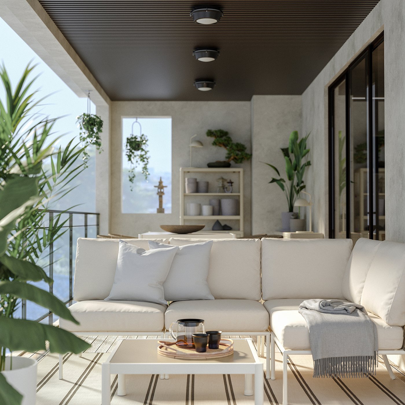 Modern outdoor living area with white sofa, rug, and plants.