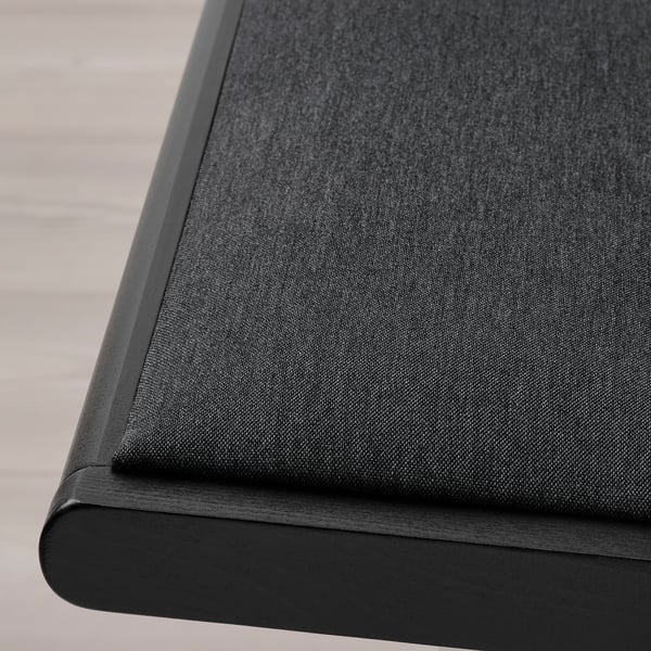 Modern chair with black upholstery & wooden frame - close-up of durable edge