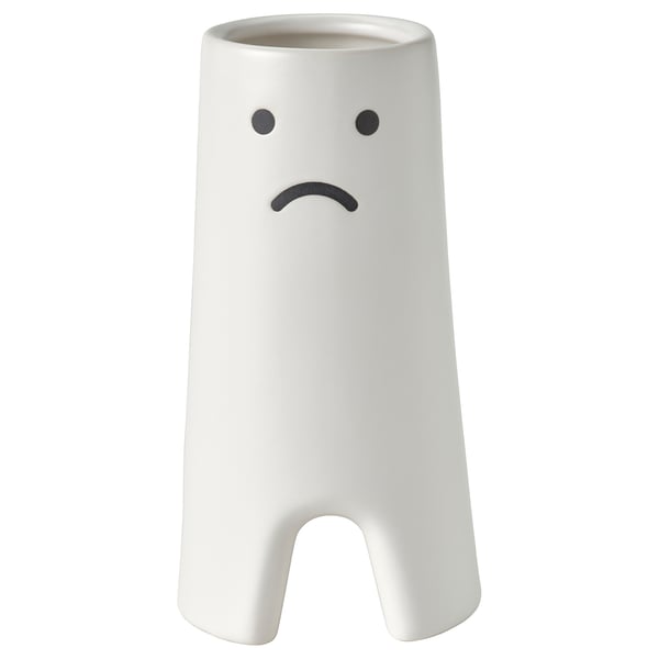 FRÖVÄXT white ceramic vase with sad face design holds flowers or decor items, made of stoneware.