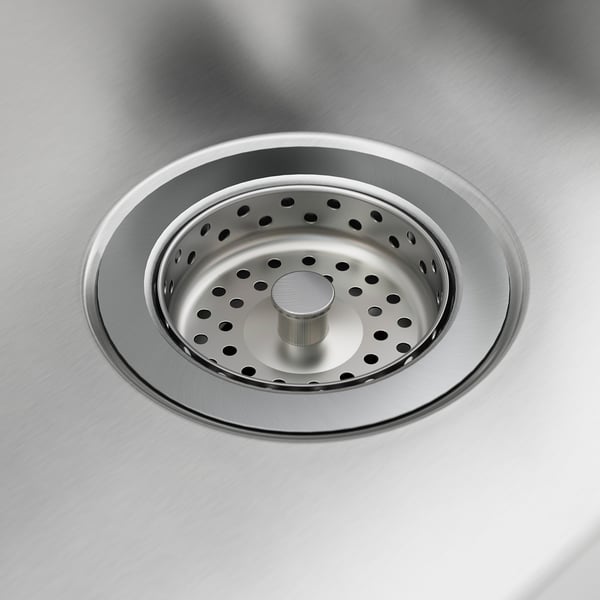 Stainless steel sink drain, gleaming and clean.
