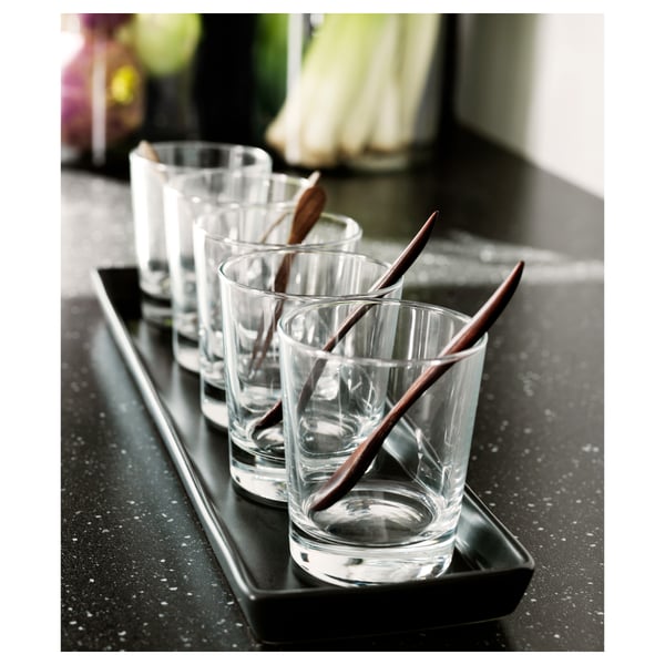 Simple, clear GODIS glasses on black tray with wooden chopsticks, perfect for cocktails or desserts.