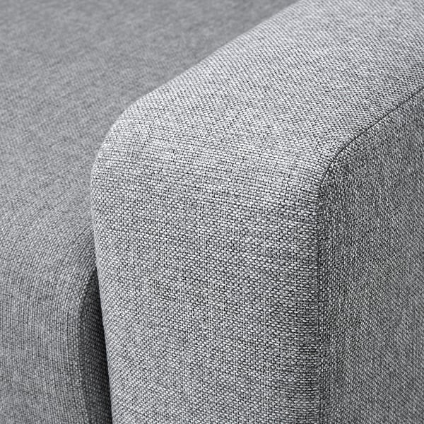 Close-up of a modern sofas corner, showcasing soft, plush grey fabric with clean stitching.