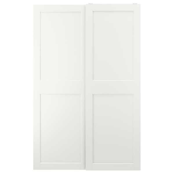 This image white GRIMO sliding closet doors. They have a clean, modern design with bold frames and bevelled edges, offering a minimalist look.