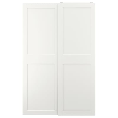 This image white GRIMO sliding closet doors. They have a clean, modern design with bold frames and bevelled edges, offering a minimalist look.
