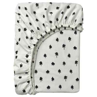 White GRÖNFINK baby sheet with black tree print. Elastic corners fit cot mattress.