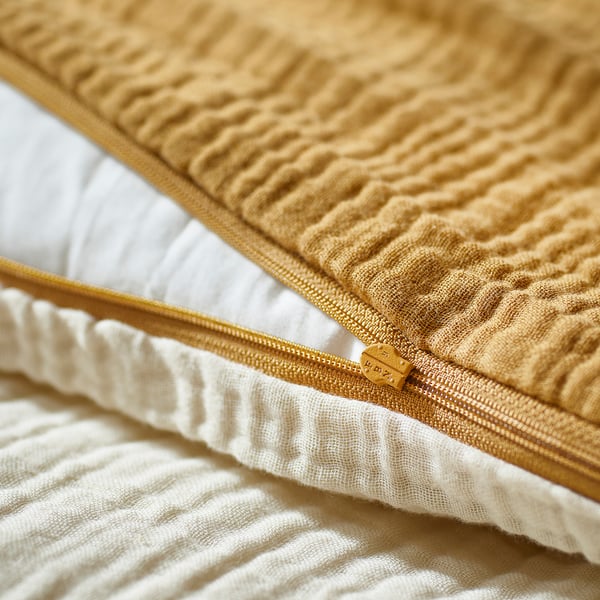 Beige bedding with zip detail in soft, organic cotton.