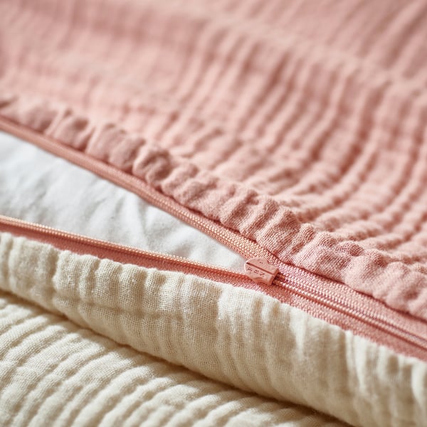 Close-up of pink GULDVÄVARE baby bedding zip, showing soft fabric & secure duvet closure.