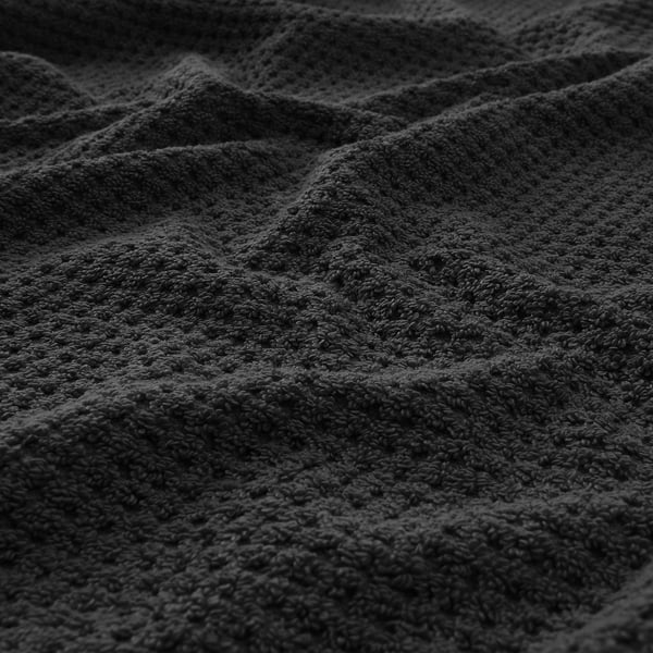 Soft, textured grey towel close-up, showcasing its plush, absorptive cotton material.