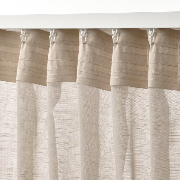 Beige sheer curtains shown with hooks, creating pleats. Allows light, offers privacy.