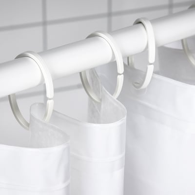 White shower curtain rod with multiple hooks holding a white shower curtain.