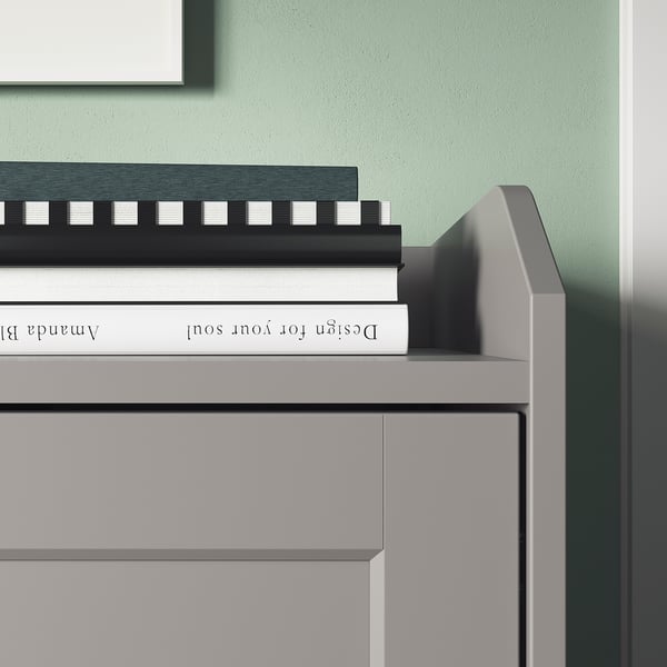 Modern grey sideboard with white books. Wood & acrylic graphics, rectangular, minimalist design.