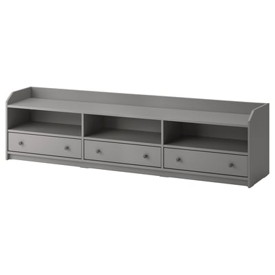 A grey HAUGA tv bench with 3 drawers and open shelves, perfect for organising accessories and keeping cables tidy.