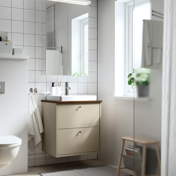 Bathroom with HAVBÄCK beige vanity, semi-recessed sink, two drawers, and mirror.