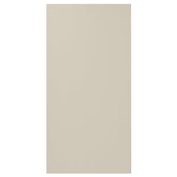 A beige rectangular HAVSTORP cabinet door. It is smooth with clean lines, made of acrylic paint and fibreboard.