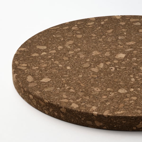Large round cork trivet displayed, textured surface for HEAT resistance.