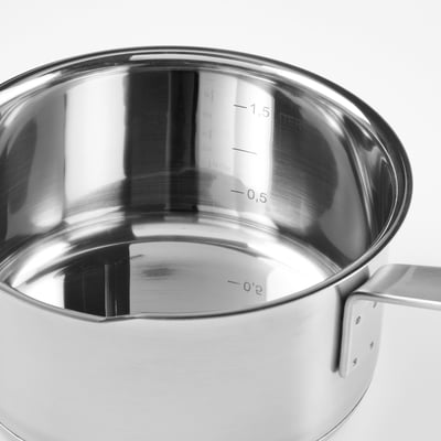 A stainless steel saucepan with a glass lid and built-in strainer, featuring a long handle for easy pouring.
