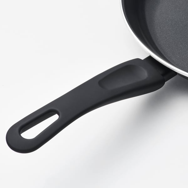 Black pan handle with grip, white body, dark non-stick interior.