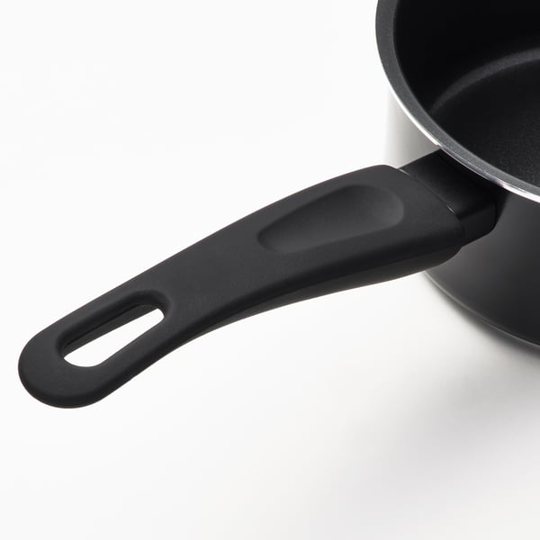 Close-up of a modern saucepan handle. Smooth, heat-resistant material. Part of sleek, easy-to-clean kitchen cookware.