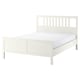 White HEMNES white bed frame, wooden, rectangular, slatted headboard.