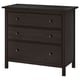 A black HEMNES chest of drawers with three drawers. It solid wood construction, a simple rectangular shape, and smooth running drawers with handles.