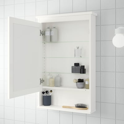 A white HEMNES mirror cabinet with a rectangular shape, framed in white, and featuring a tempered glass shelf.