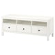 A white HEMNES tv stand made of pine with drawers and shelves for storage. It has a rectangular shape and clean design.