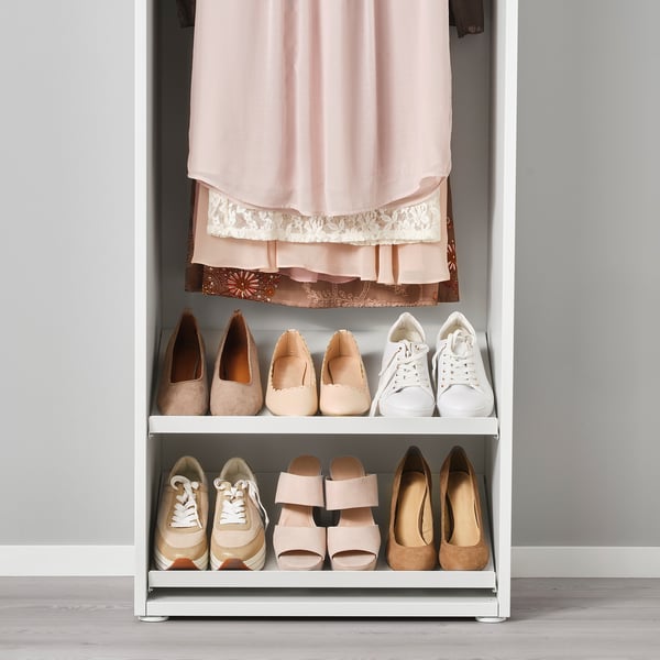 Closet organiser with shoe shelves and hanging rod. Shoes and garment displayed neatly.