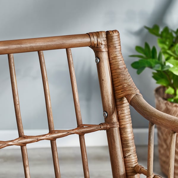 Handwoven rattan armchair detail, natural materials, intricate design, smooth lines