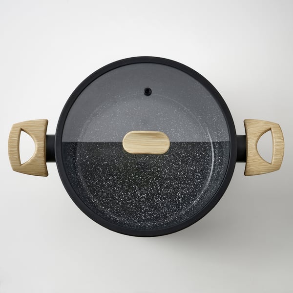 Black skillet with wooden handles and glass lid, showcasing high-quality ceramic non-stick coating.