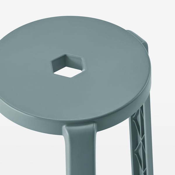 A sturdy, three-legged stool made of durable, recycled plastic material. It has a circular seat and is designed for stability and ease of stacking.