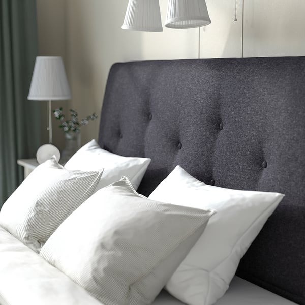 Cosy bed with grey headboard, white pillows, and lamps. Soft-closing drawers under bed.