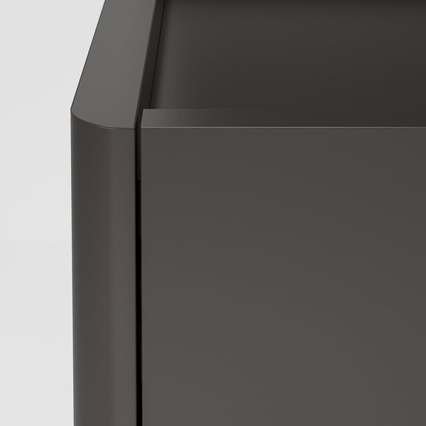 Modern black cabinet with sleek, smooth finish and clean lines, featuring metal handles and edges, showcasing high-quality design.