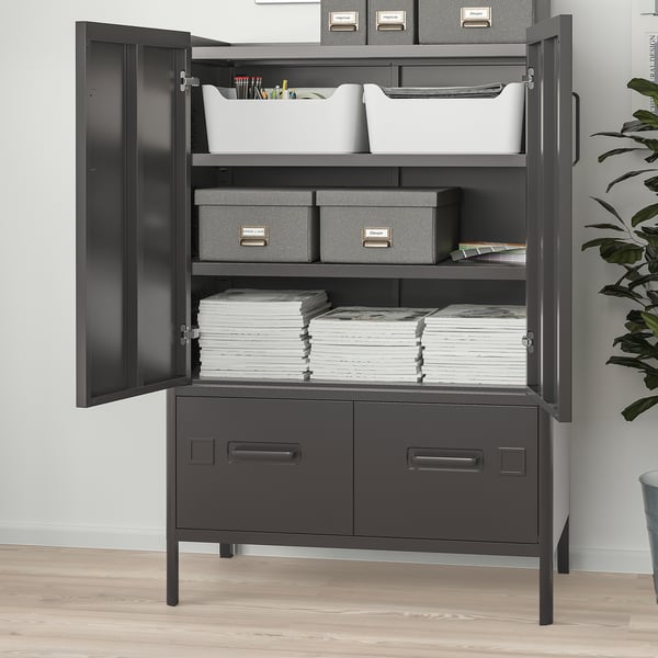 Black metal storage cabinet with two open doors revealing organised stacks of paper, boxes, and a bin of supplies. Also two drawers.